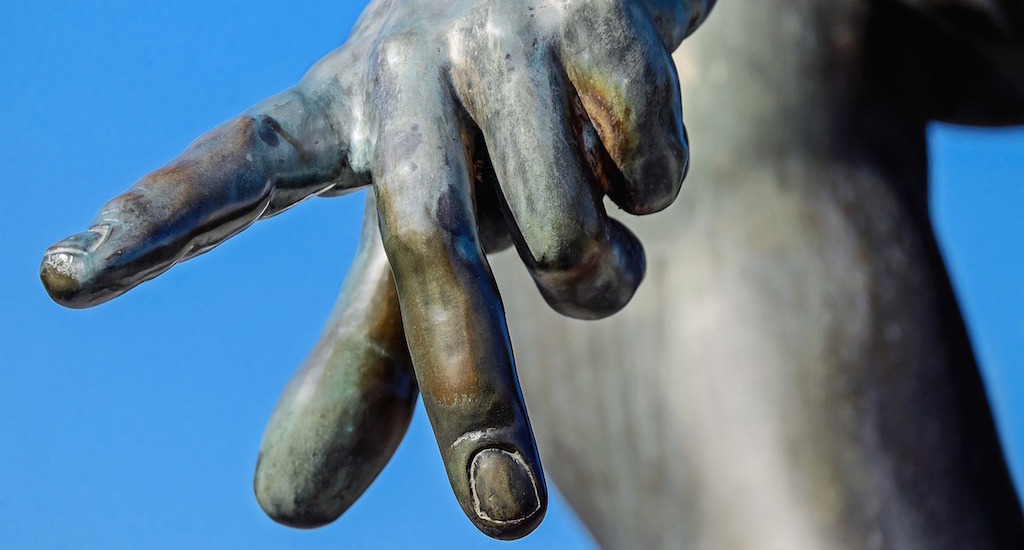 Extended index finger of a statue