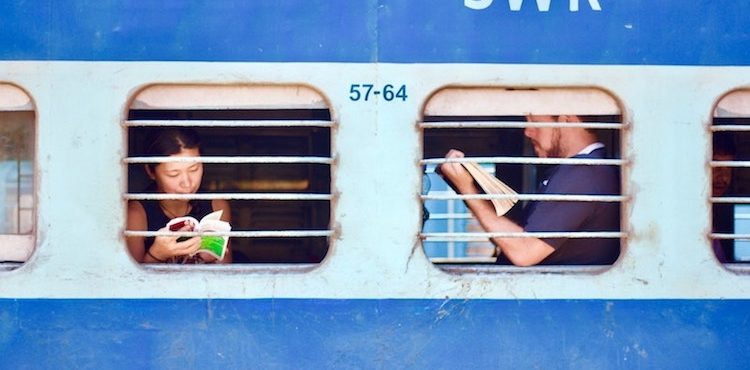 Train riders framed in their individual window screens