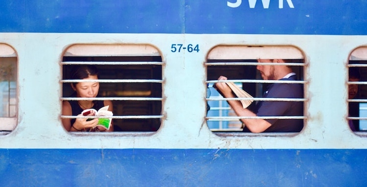 Train riders framed in their individual window screens