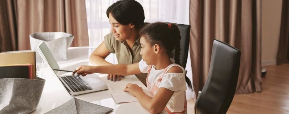 mother helping daughter with homework Online education eLearning