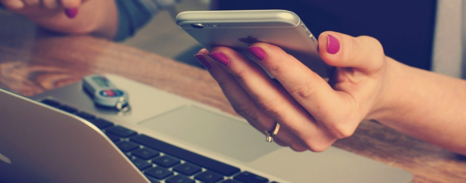 break up with bad ux design woman holding mobile phone in front of laptop